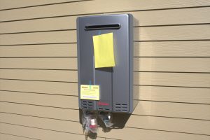 Tankless water heater installed on exterior of building at OCIC