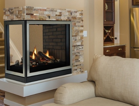 A multi-sided fireplace next to a couch