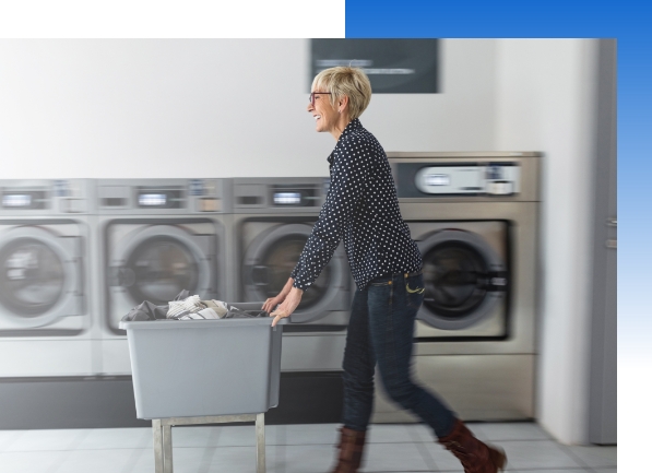 A person with a basket of clothes in a laundry