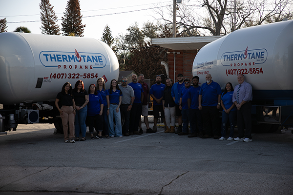Thermotane employees in front of two propane trucks